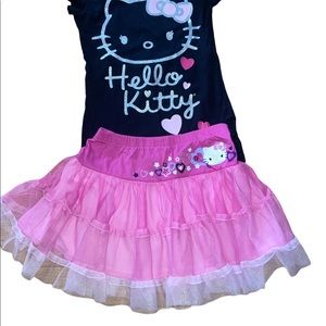 Hello kitty black short sleeve top and pink ruffled tiered slip on skirt.